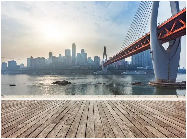 A bridge over water with a city in the background.